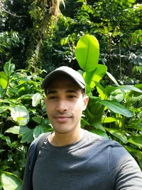 A picture of Nelson Dominguez with plants in the background